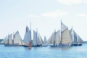 Members of the Maine Windjammer ASsociation fleet parade by the Rockland Breakwater Lighthouse during the annual Parade of Sail in 2011. Tom Nangle photo.