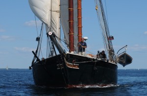 Windjammers sail very close to each other during the annual Parade of Sail, by Rockland Breakwater Lighthouse, in Maine. HEre the Tabor is hard on the stern of the Lewis R. French. Tom nangle photo