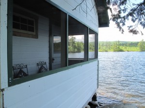 If the water were deeper, you could practically dive out the windows or off the porch from this cabin at Castle Island Camps into the waters of Long Pond. Hilary Nangle photo.