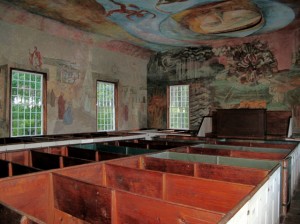 Primitive pews are juxtaposed against contemporary frescoes inside the South Solon Meeting House. Hilary Nangle photo