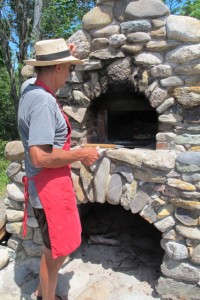 Slideing a pizza into Seal Cove Farm's outdoor oven. Hilary Nangle photo. IMG_3724