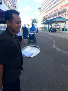 Holland America Line welcomes its cruise passengers back to the ship with a refreshing cool cloth. ©Hilary Nangle 