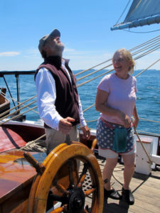 Capt. Jon Finger at the wheel of the schooner J&E Riggin. ©Hilary Nangle