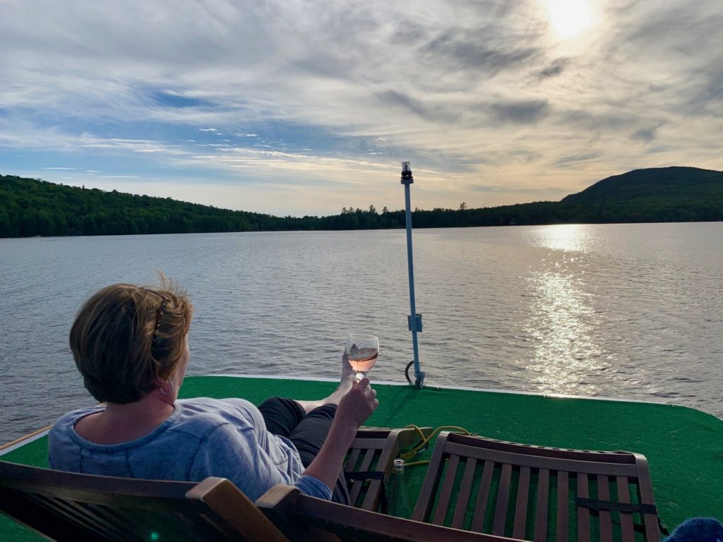 relaxing in a chaise lounge on the Floating Nomad's upper fore deck. 