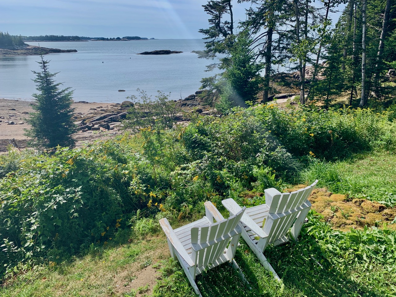 Adirondack chairs positioned for the view at Aragosta, Deer Isle