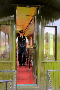 Conductor aboard train at Boobay Railway Village