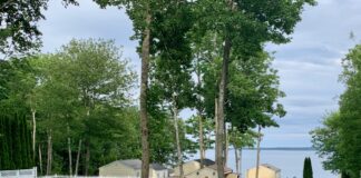 View taking in the pool, staggered cottages, and Penobscot Bay taken from above the lower pool at Glenmoor by the Sea.