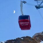 Tram approaches the summmit of Switzerland's Mount Pilatus under a sliver of moon