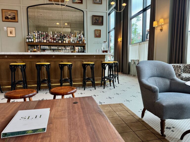 The Five of Clubs lounge has a handsome full bar backed by a mirror and varied seating.