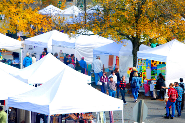 Images shows craft vendors tents at the annual free family-oriented fun Freeport Fall Festival